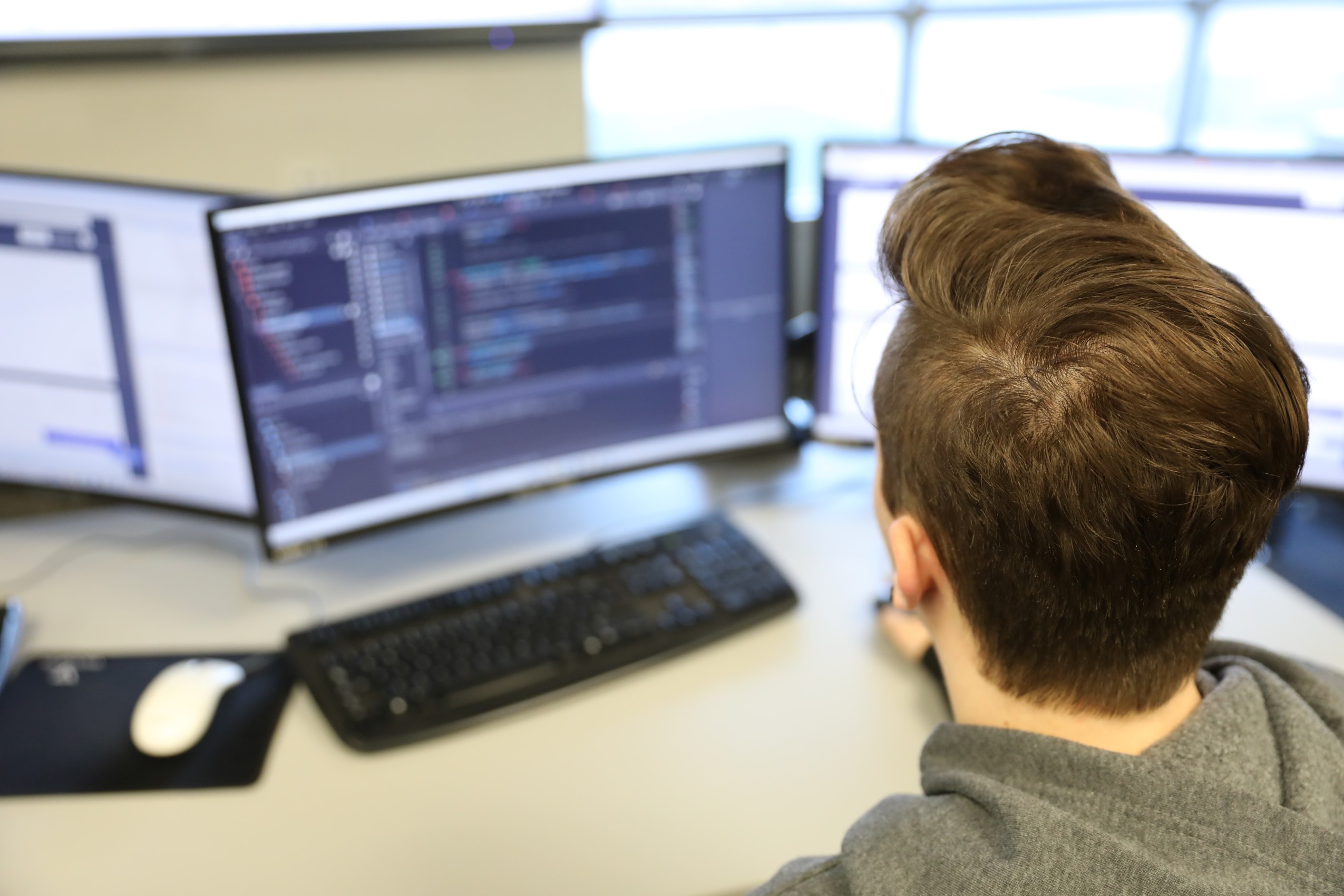 A student coding at a computer